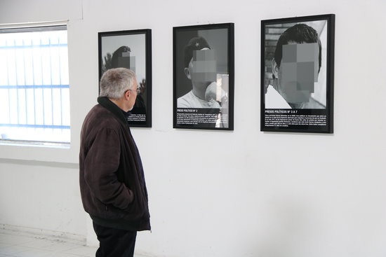 A museum-goer looks at photos at the ARCO exhibit in Madrid on February 25 2019 (by Andrea Zamorano)